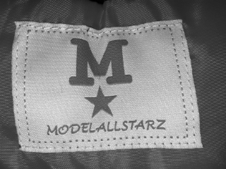 m with a star underneath. also, the brandname modelallstarz