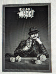 tic tac whack with an exclamation point made out of a dollar bill.  there is a dollar sign between the "tic and tac".  the dice have several sides showing a "give right"  "whack whack!" an "8" and a "5". one side of the dice also depicts the words "take l