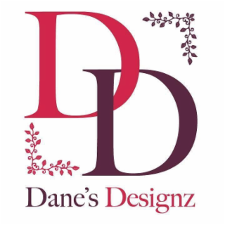 the mark consists of a stylized overlapping capital letter “d” in shades of red and pink layered over a stylized capital letter “d” in burgundy, with decorative floral vine elements positioned in the upper right and lower left corners. beneath the design 